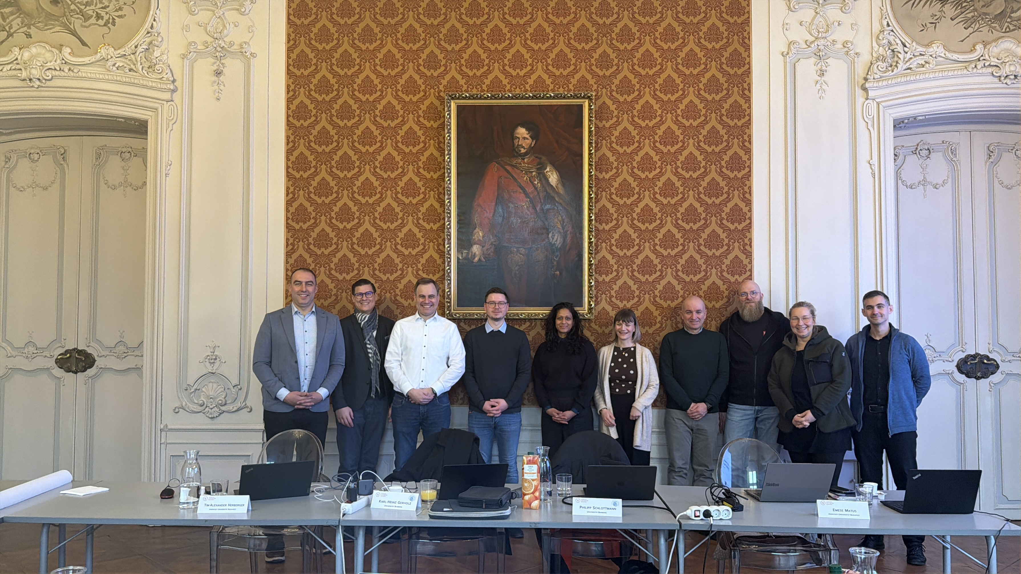 The project team in the historic Andrassy Ball Room, with name plates and laptops on the conference table